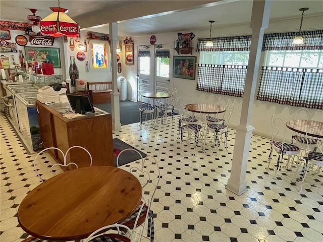 273 N Main St, Eureka Springs, AR 72632 - dining space featuring tile patterned floors, ornate columns, and baseboards