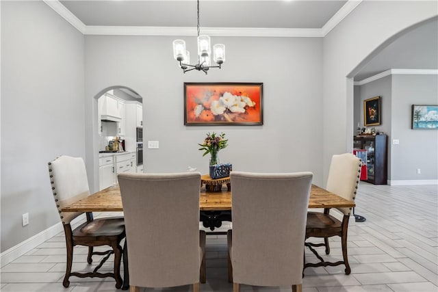 2300 Cameo Ln, Bentonville, AR 72712 - dining area featuring arched walkways, a chandelier, crown molding, and baseboards