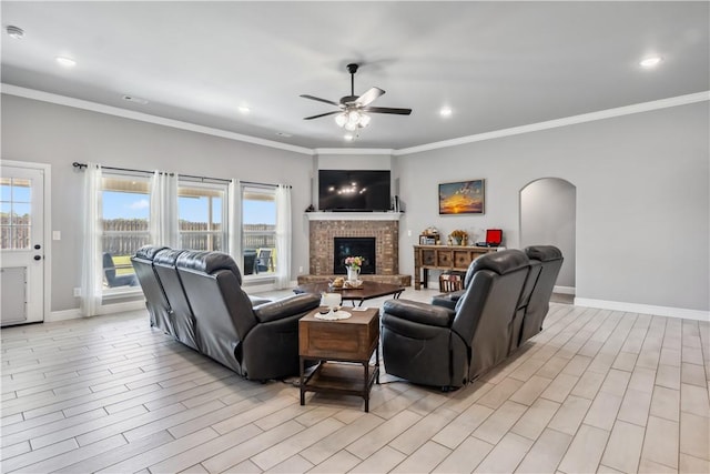 2300 Cameo Ln, Bentonville, AR 72712 - living room featuring arched walkways, a ceiling fan, healthy amount of natural light, baseboards, and crown molding