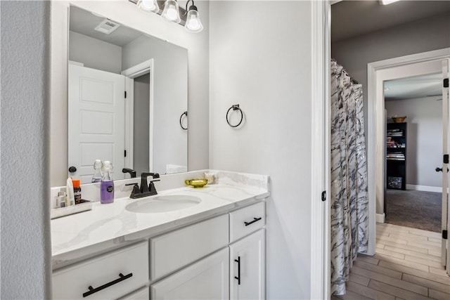 2300 Cameo Ln, Bentonville, AR 72712 - bathroom featuring vanity, wood finished floors, and baseboards