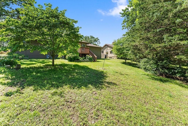 4 Wincanton Ln, Bella Vista, AR 72715 - view of green lawn featuring stairway and a wooden deck