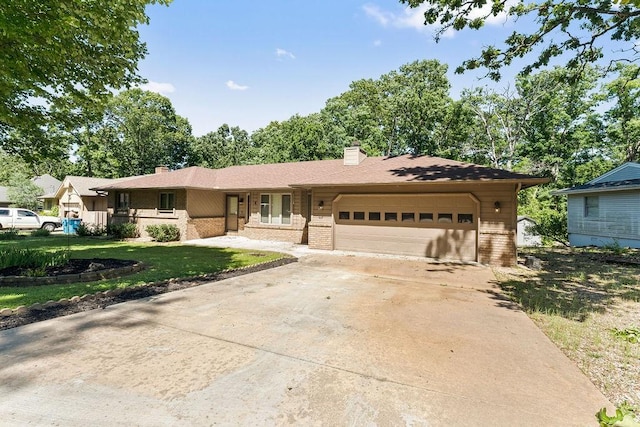4 Wincanton Ln, Bella Vista, AR 72715 - ranch-style house with brick siding, a chimney, a garage, concrete driveway, and a front lawn