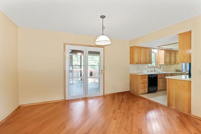 4 Wincanton Ln, Bella Vista, AR 72715 - kitchen featuring dishwasher, light countertops, light wood-type flooring, plenty of natural light, and a textured ceiling