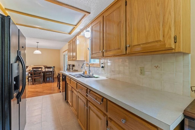 4 Wincanton Ln, Bella Vista, AR 72715 - kitchen featuring black appliances, a sink, tasteful backsplash, light countertops, and decorative light fixtures