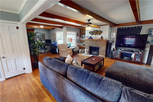 220 W Highland St, Siloam Springs, AR 72761 - living area with a ceiling fan, beamed ceiling, wood finished floors, and a brick fireplace