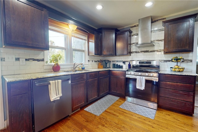 220 W Highland St, Siloam Springs, AR 72761 - kitchen with stainless steel appliances, a sink, island range hood, light wood-style floors, and tasteful backsplash