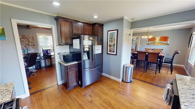 220 W Highland St, Siloam Springs, AR 72761 - kitchen featuring stainless steel appliances, light wood-type flooring, crown molding, dark brown cabinetry, and a chandelier