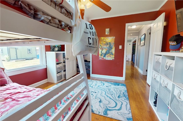 220 W Highland St, Siloam Springs, AR 72761 - bedroom with wood finished floors, baseboards, and crown molding