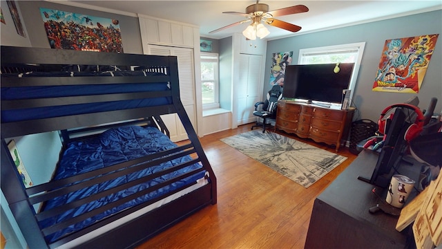 220 W Highland St, Siloam Springs, AR 72761 - bedroom featuring wood finished floors and multiple windows