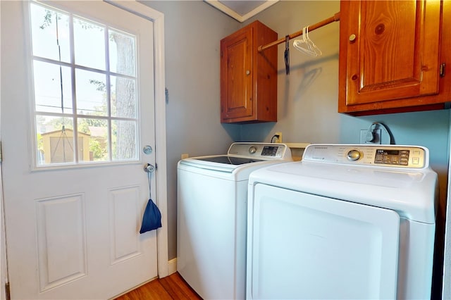 220 W Highland St, Siloam Springs, AR 72761 - laundry area with washer and dryer, cabinet space, and light wood-type flooring