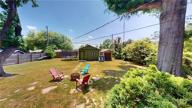 220 W Highland St, Siloam Springs, AR 72761 - view of yard featuring a fire pit and a trampoline