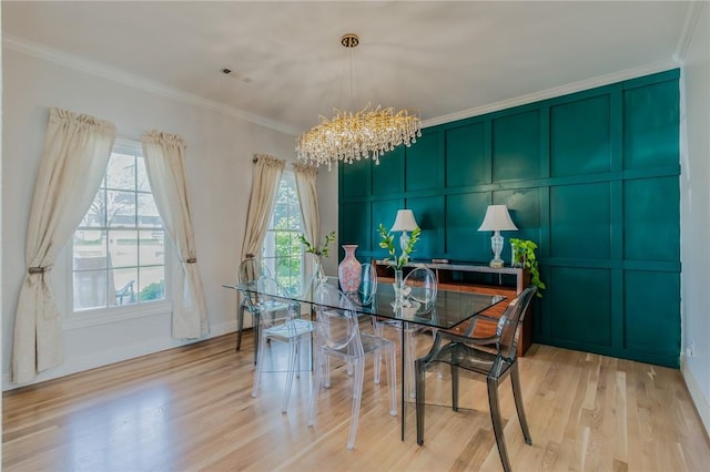 4 W Colonial Dr, Rogers, AR 72758 - dining space featuring a chandelier, ornamental molding, light wood-style flooring, a decorative wall, and baseboards