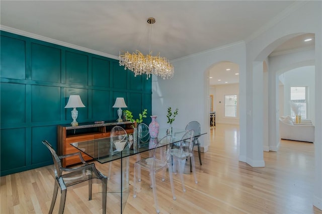 4 W Colonial Dr, Rogers, AR 72758 - dining room featuring a decorative wall, crown molding, a chandelier, light wood-type flooring, and arched walkways