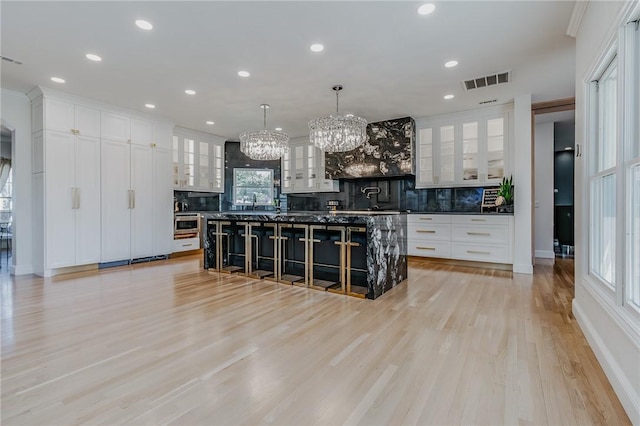 4 W Colonial Dr, Rogers, AR 72758 - kitchen with a chandelier, tasteful backsplash, a spacious island, white cabinetry, and recessed lighting