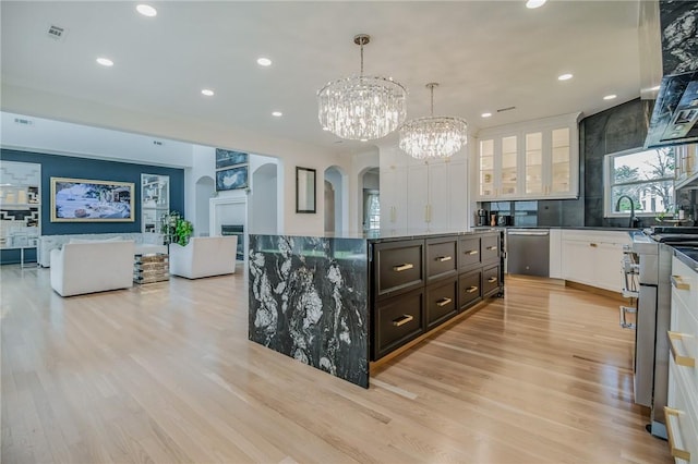 4 W Colonial Dr, Rogers, AR 72758 - kitchen featuring arched walkways, stainless steel dishwasher, a chandelier, white cabinetry, and recessed lighting