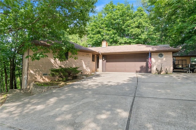 3 Summit Dr, Holiday Island, AR 72631 - view of front of house featuring brick siding, an attached garage, driveway, and a chimney