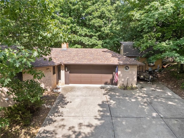 3 Summit Dr, Holiday Island, AR 72631 - view of front facade with brick siding, an attached garage, driveway, and a chimney