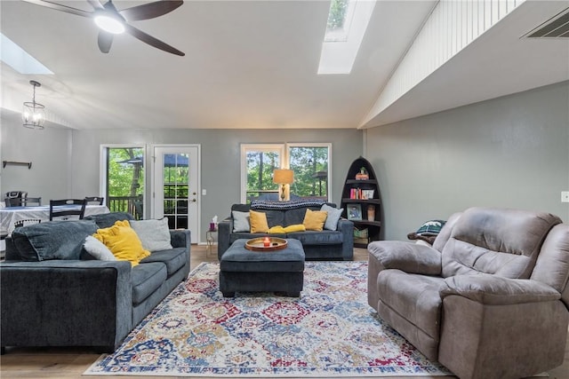 3 Summit Dr, Holiday Island, AR 72631 - living room featuring a skylight, vaulted ceiling, wood finished floors, and healthy amount of natural light
