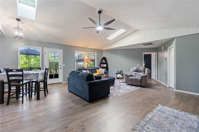 3 Summit Dr, Holiday Island, AR 72631 - living area featuring a skylight, vaulted ceiling, a ceiling fan, and wood finished floors