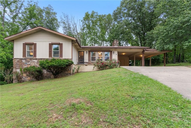 81 Overton Dr, Bella Vista, AR 72714 - single story home with driveway, a chimney, a front yard, a carport, and stone siding