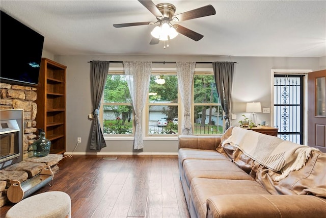 81 Overton Dr, Bella Vista, AR 72714 - living room with wood finished floors, baseboards, a ceiling fan, healthy amount of natural light, and a textured ceiling