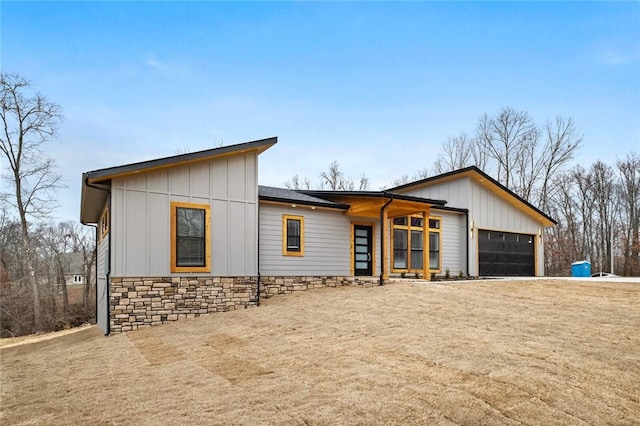 1 Dunholme Dr, Bella Vista, AR 72714 - view of front facade with a garage, board and batten siding, stone siding, and driveway