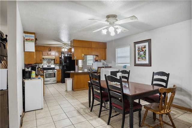 309 Sanders Ave, Springdale, AR 72764 - dining area featuring a ceiling fan, light tile patterned floors, and a textured ceiling