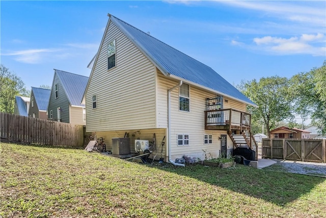 413 W Tahlequah St, Siloam Springs, AR 72761 - rear view of house featuring metal roof, ac unit, central air condition unit, and a deck