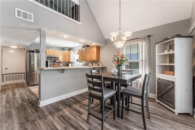 413 W Tahlequah St, Siloam Springs, AR 72761 - dining space with a chandelier, dark wood finished floors, baseboards, and high vaulted ceiling