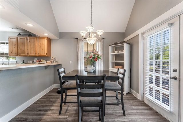 413 W Tahlequah St, Siloam Springs, AR 72761 - dining room with lofted ceiling, a chandelier, baseboards, dark wood-style flooring, and recessed lighting