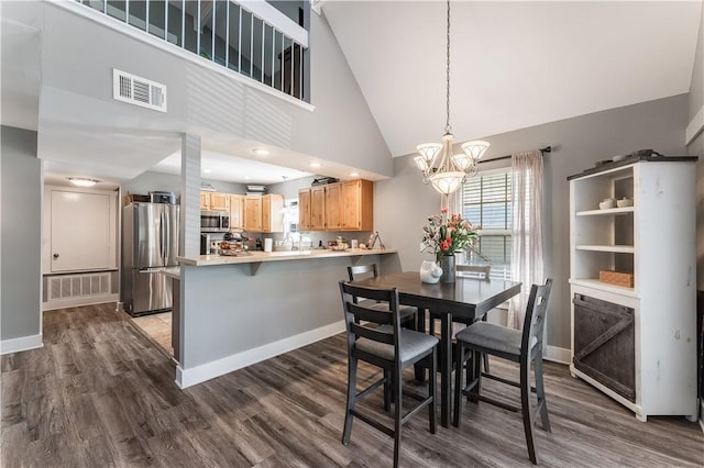 413 W Tahlequah St, Siloam Springs, AR 72761 - dining space with a chandelier, dark wood-style flooring, high vaulted ceiling, and baseboards