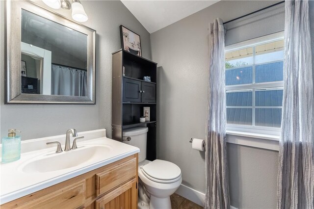 413 W Tahlequah St, Siloam Springs, AR 72761 - full bathroom featuring toilet, vaulted ceiling, vanity, and baseboards