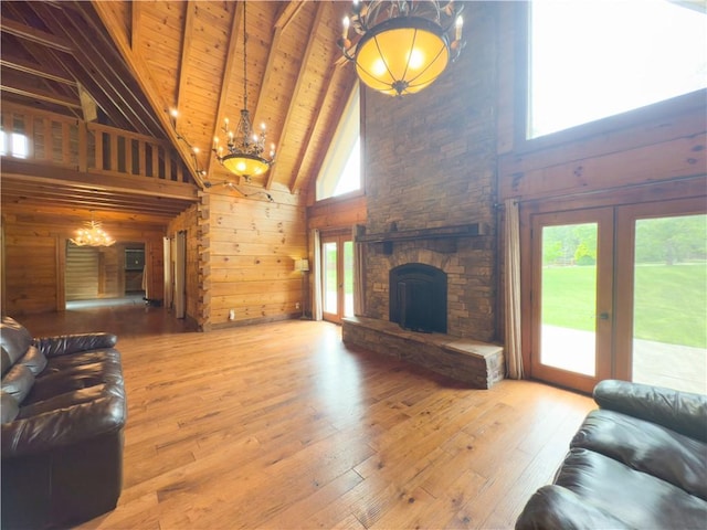 463 County Road 2281, Eureka Springs, AR 72631 - living area with a chandelier, high vaulted ceiling, wood ceiling with exposed beams, wood-type flooring, and wooden walls