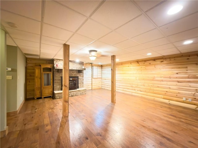 463 County Road 2281, Eureka Springs, AR 72631 - finished below grade area featuring a paneled ceiling, a stone fireplace, wood finished floors, wooden walls, and baseboards