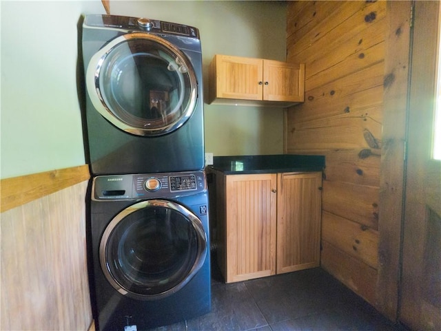463 County Road 2281, Eureka Springs, AR 72631 - washroom with estacked washer and dryer, cabinet space, and dark tile patterned floors