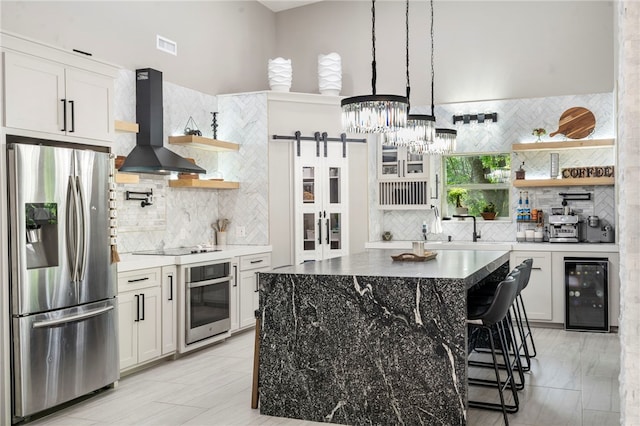 18097 Clear Water Rd, Fayetteville, AR 72704 - kitchen with appliances with stainless steel finishes, wall chimney range hood, beverage cooler, and open shelves
