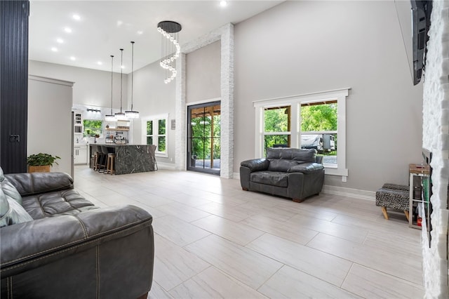 18097 Clear Water Rd, Fayetteville, AR 72704 - living area featuring a towering ceiling, baseboards, and recessed lighting