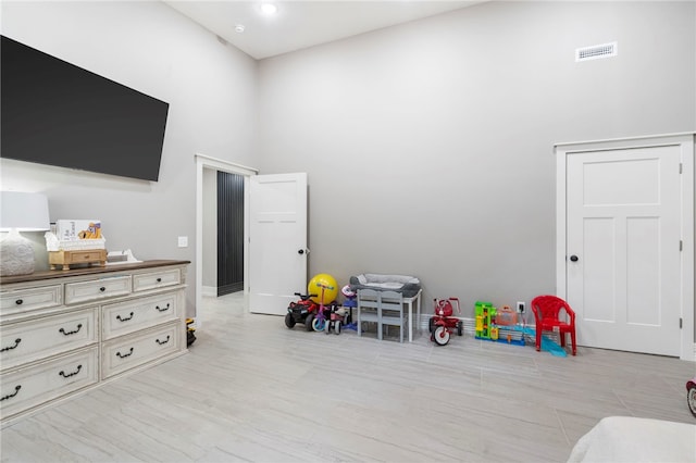 18097 Clear Water Rd, Fayetteville, AR 72704 - recreation room featuring a towering ceiling and light wood finished floors