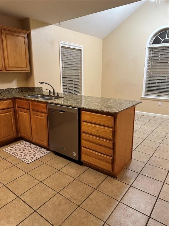 20944 Shady Grove Rd, Siloam Springs, AR 72761 - kitchen featuring stainless steel dishwasher, a sink, a peninsula, light tile patterned floors, and dark stone counters