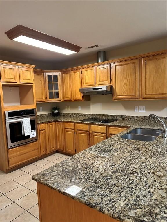20944 Shady Grove Rd, Siloam Springs, AR 72761 - kitchen with stainless steel oven, under cabinet range hood, black electric cooktop, a sink, and light tile patterned floors