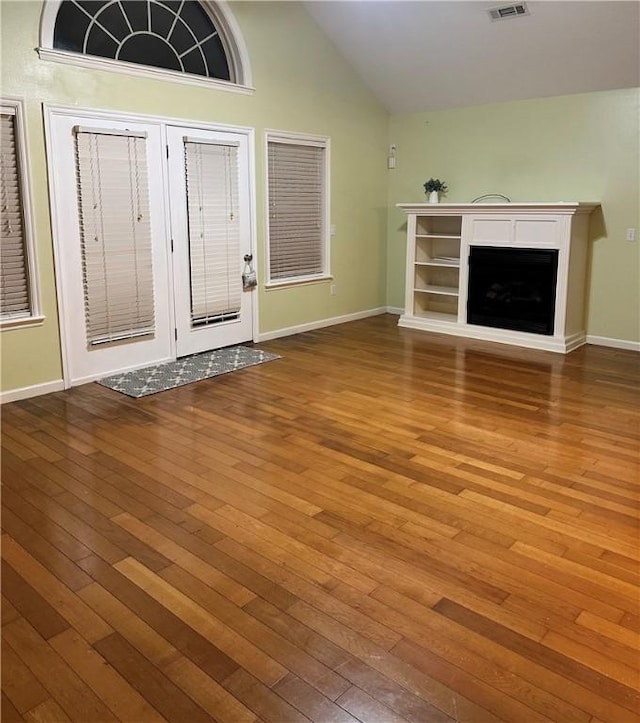 20944 Shady Grove Rd, Siloam Springs, AR 72761 - unfurnished living room with hardwood / wood-style floors, a fireplace, baseboards, and high vaulted ceiling