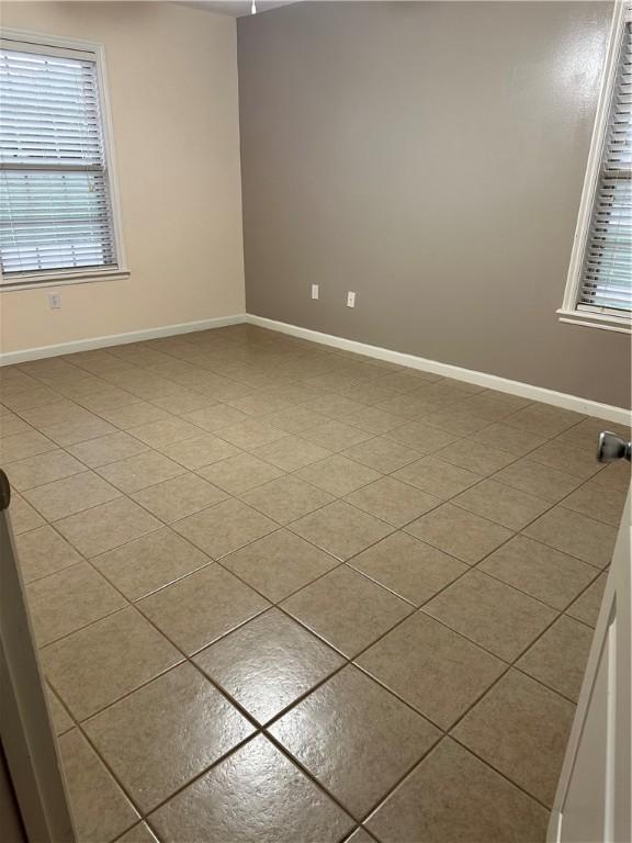20944 Shady Grove Rd, Siloam Springs, AR 72761 - tiled empty room with plenty of natural light and baseboards