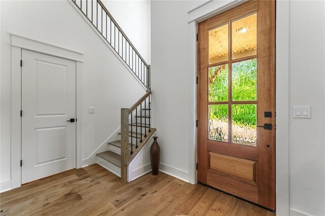 41 Westmorland Dr, Bella Vista, AR 72714 - foyer with light wood finished floors, stairway, and baseboards