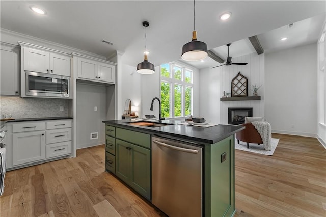 41 Westmorland Dr, Bella Vista, AR 72714 - kitchen featuring appliances with stainless steel finishes, green cabinets, dark countertops, a sink, and beamed ceiling