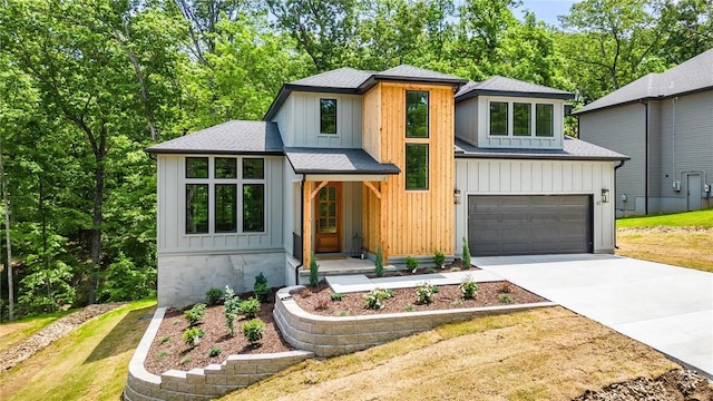 41 Westmorland Dr, Bella Vista, AR 72714 - view of front of home featuring a shingled roof, driveway, an attached garage, and board and batten siding