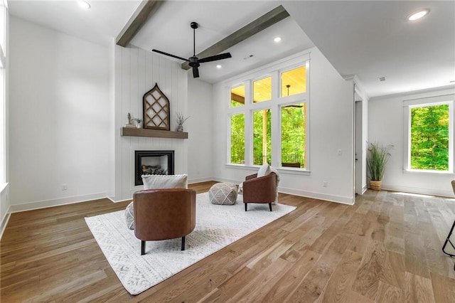 41 Westmorland Dr, Bella Vista, AR 72714 - living area featuring a ceiling fan, a large fireplace, baseboards, wood finished floors, and beamed ceiling