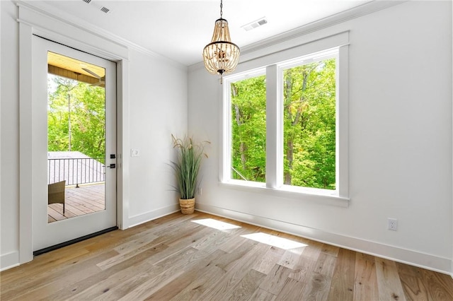 41 Westmorland Dr, Bella Vista, AR 72714 - unfurnished dining area featuring crown molding, plenty of natural light, a chandelier, wood finished floors, and baseboards