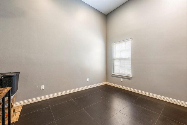 29 Kentallen Ln, Bella Vista, AR 72715 - empty room featuring dark tile patterned floors and a towering ceiling