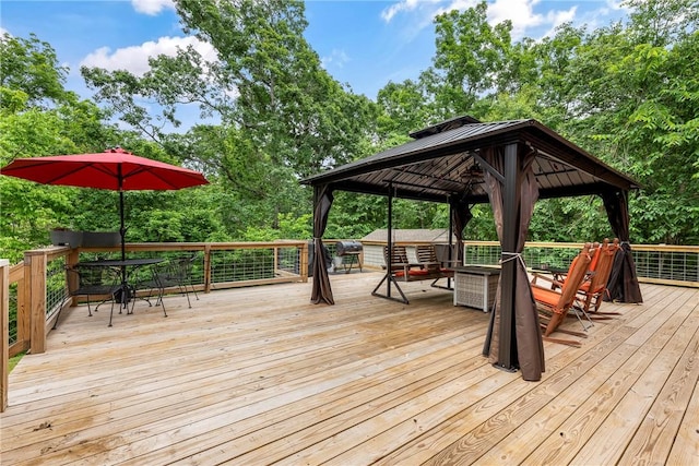 29 Kentallen Ln, Bella Vista, AR 72715 - deck with a gazebo, outdoor dining space, and view of wooded area