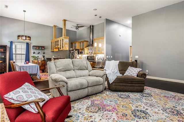 29 Kentallen Ln, Bella Vista, AR 72715 - living area with a high ceiling, wood finished floors, and baseboards
